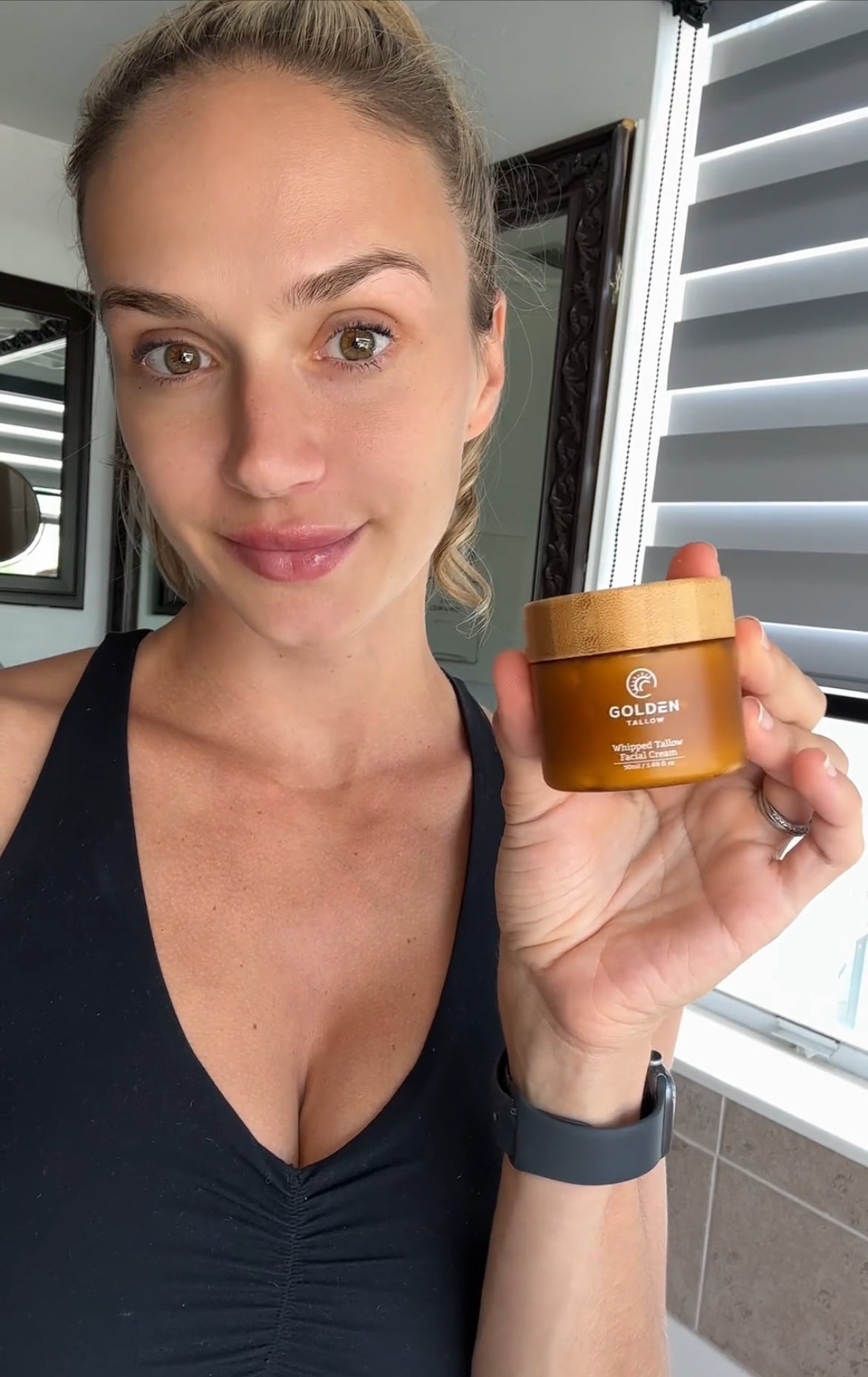 Woman holding Golden Tallow face cream