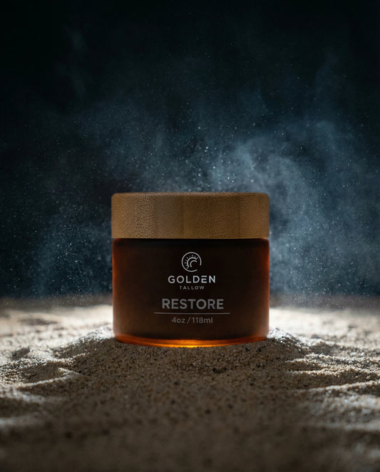 Jar of 'Restore' by Golden Tallow on a dark background with dust effect CBD cream